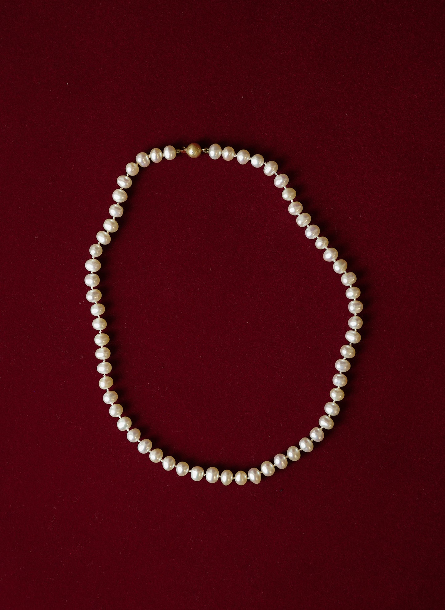 Pearl necklace with gold clasp