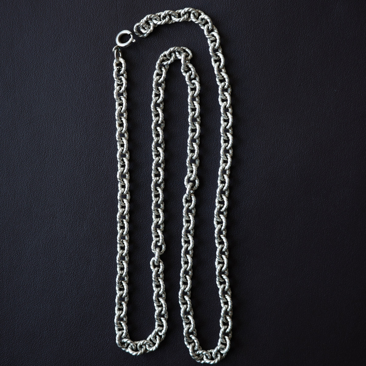 Twisted cable link chain