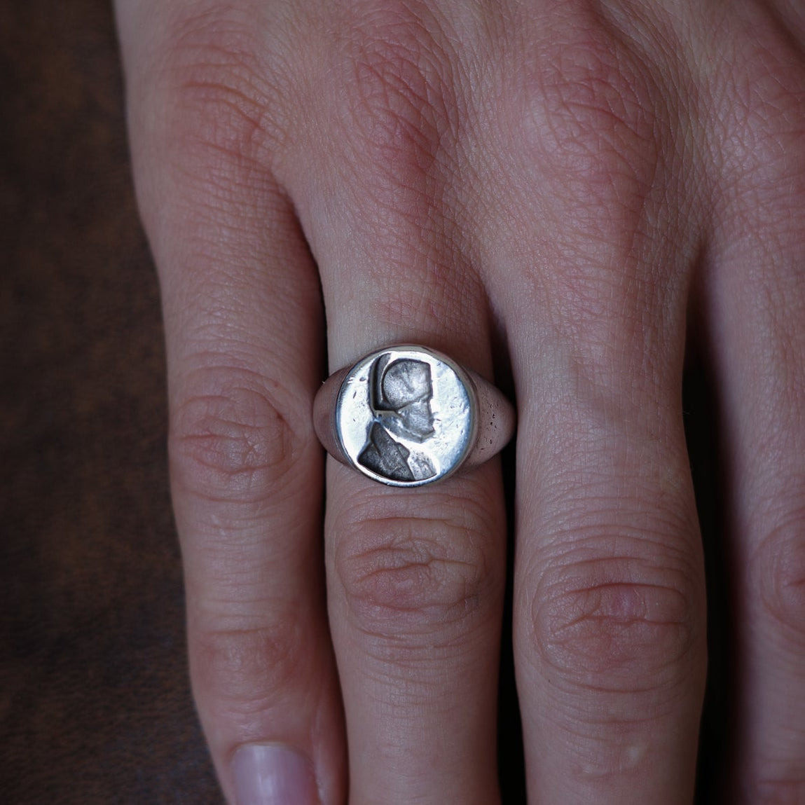 Embossed bust signet ring