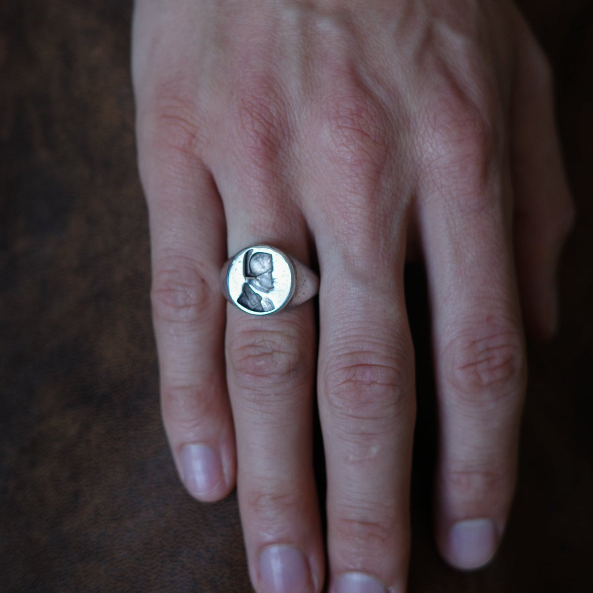 Embossed bust signet ring