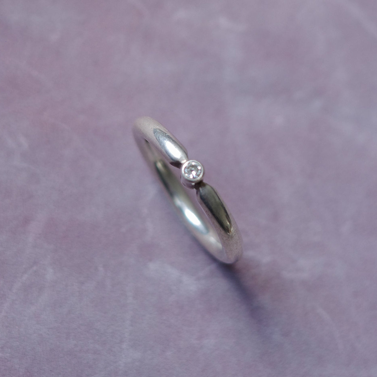 Band ring with embossed diamond