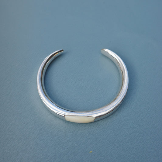 Silver cuff with a soft ivory inlay